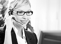 A woman wearing a headset is talking on the phone