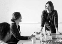 People are gathered around a boardroom table having a discussion