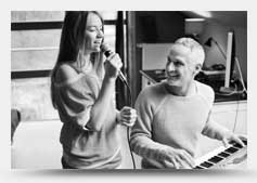 Image of woman singing and man on keyboard