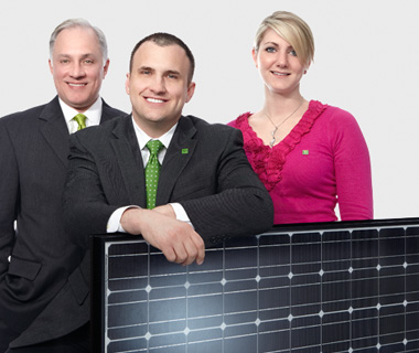 photo of TD employees holding a solar panel