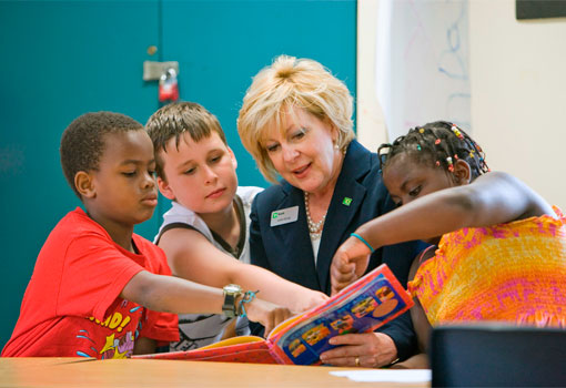Photo of TD employee reading to children