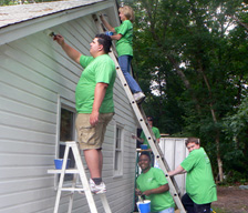 TD employees painting a house