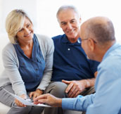 Middle-aged couple confidently investing with a TD Waterhouse Financial Planner.