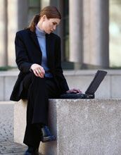 Businesswoman researching mutual funds on a laptop